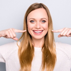 woman pointing to her mouth