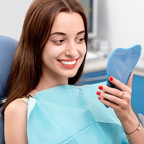 Woman looking at smile in mirror