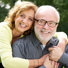 Smiling older man and woman outdoors