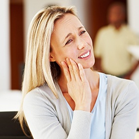 Woman holding jaw in pain