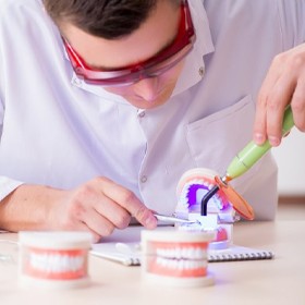 A man working on a mold of veneers