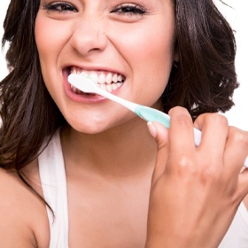 A young woman brushing her teeth