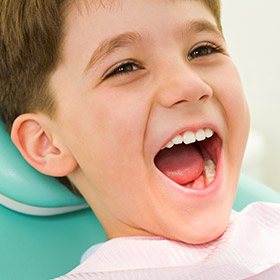 Smiling little boy in dental chair